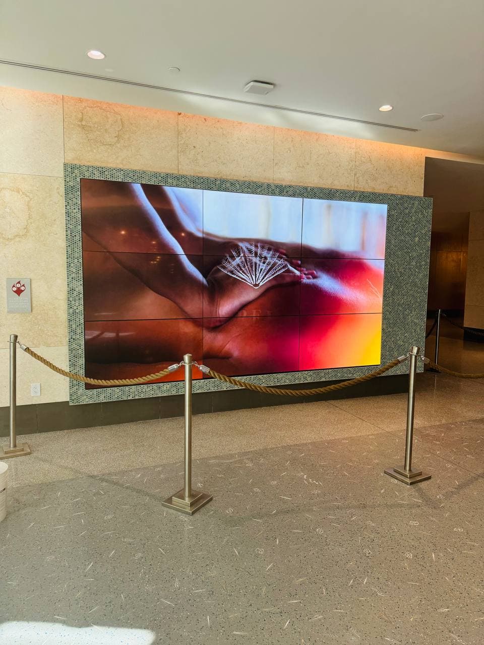 Resort lobby with a large video wall framed by mosaic tile