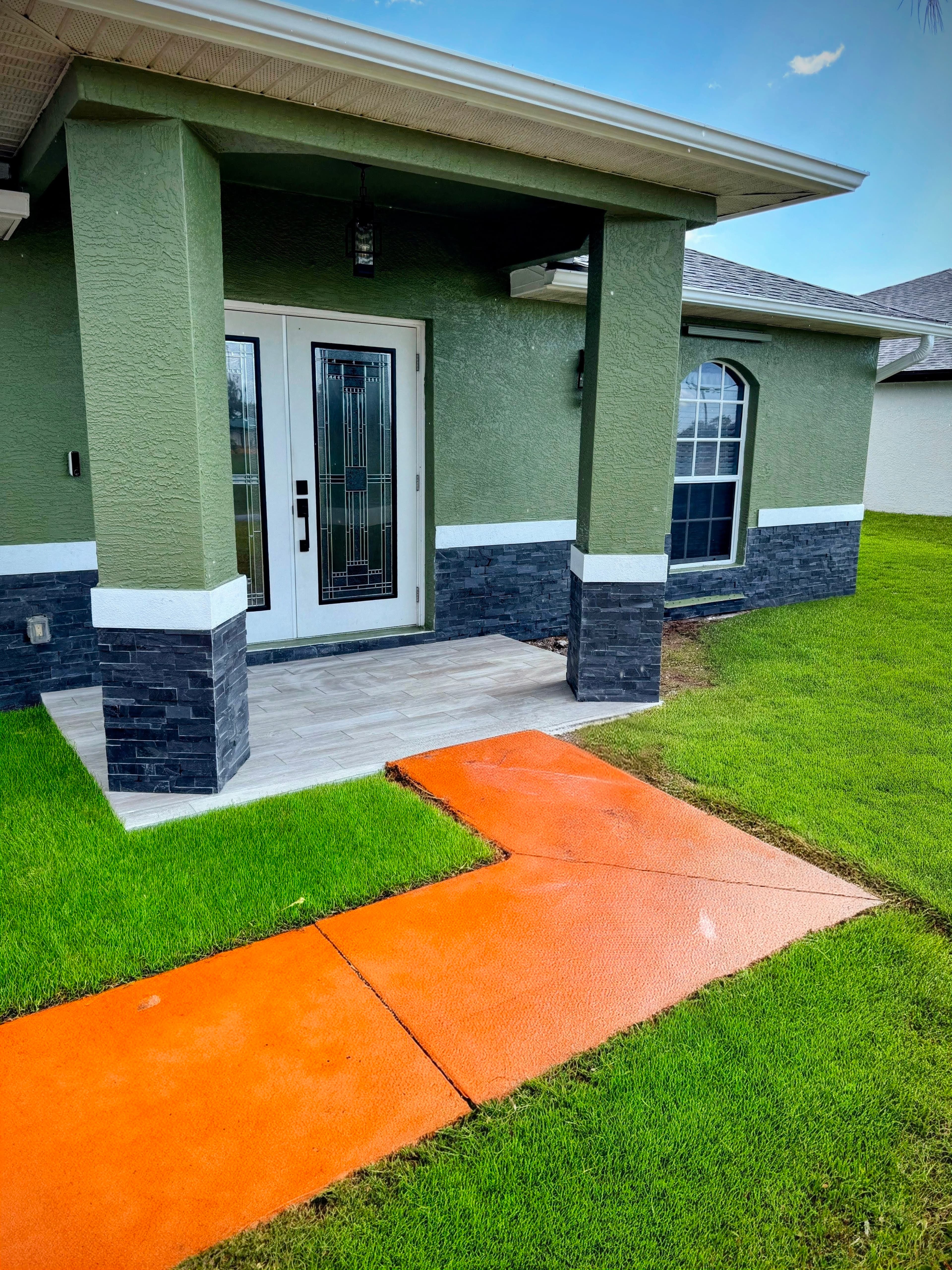 Front porch and entry with stacked-stone veneer and tile flooring