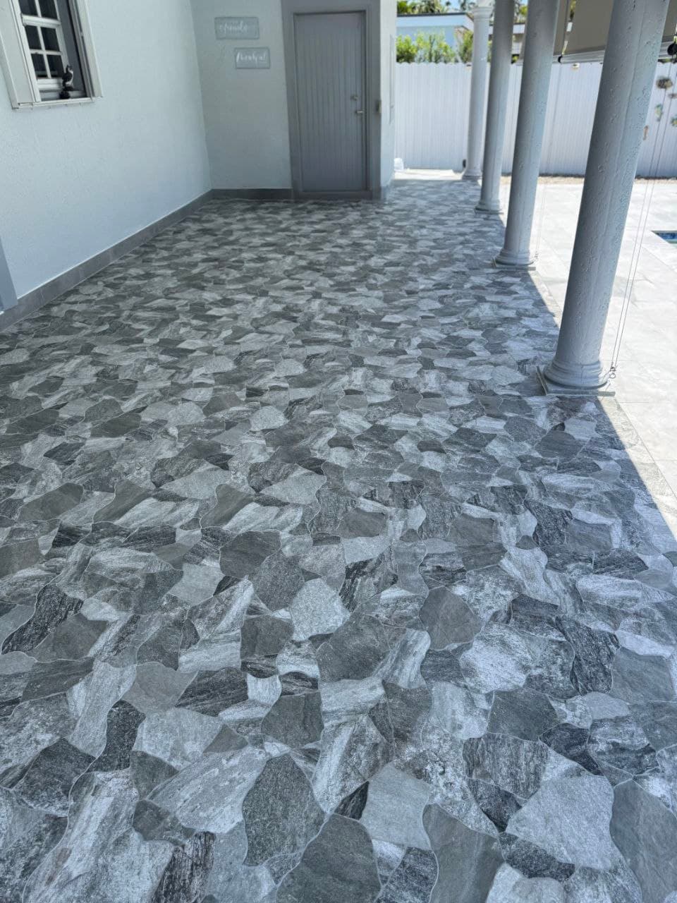 Covered patio with gray patterned tile flooring